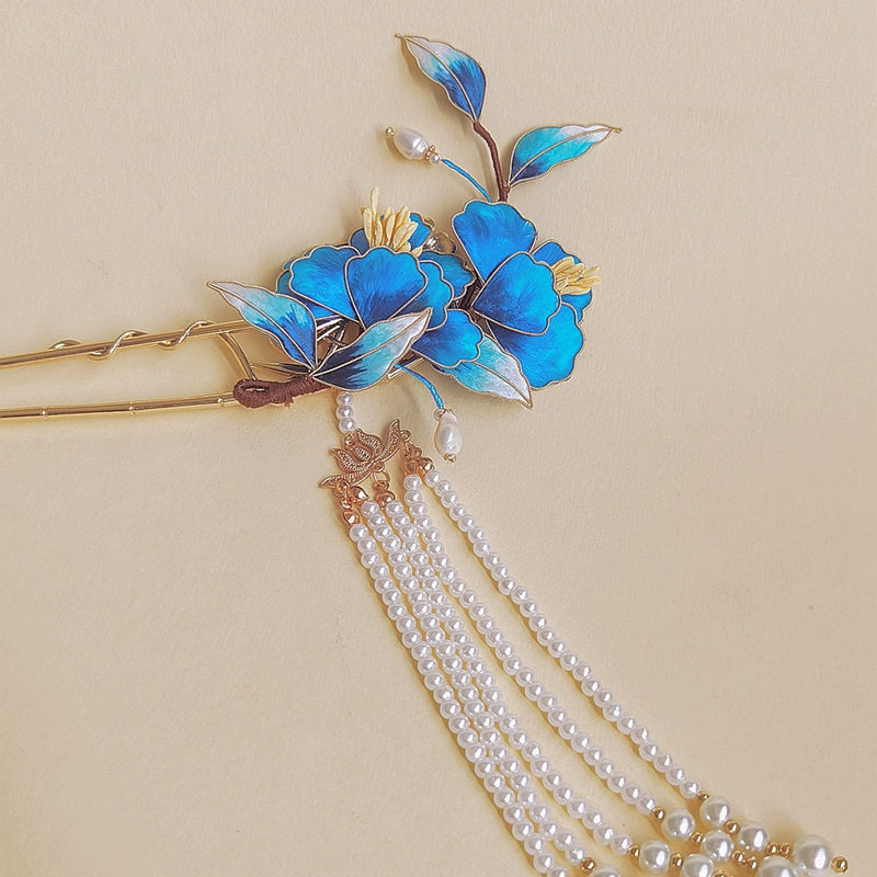Rear view of low bun secured with decorative floral hair stick