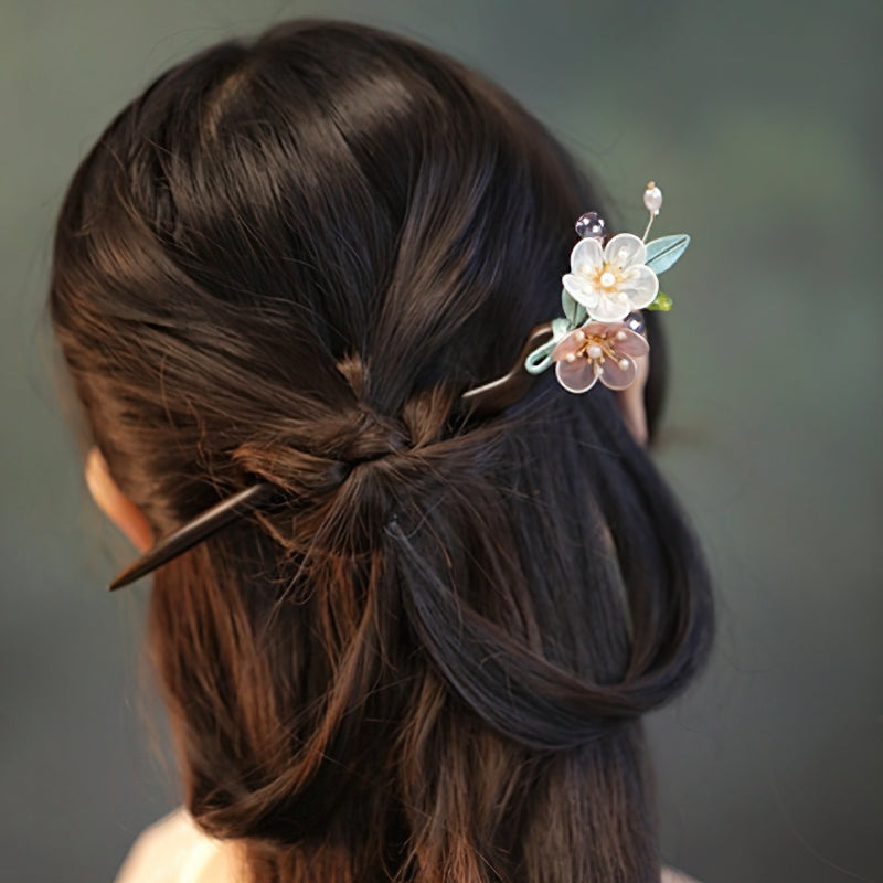 Hair stick slid through an elegant low bun, accenting a bridal hairstyle