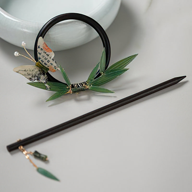Slim dark stick photographed from above with simple neutral backdrop