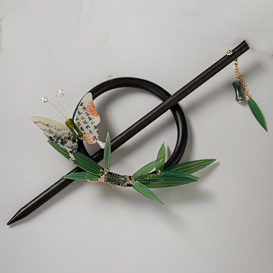 Dark wood-toned hair stick resting diagonally on pale fabric surface