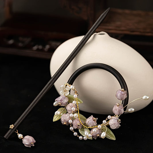 Dark wood hair stick resting across a low bun on brown hair