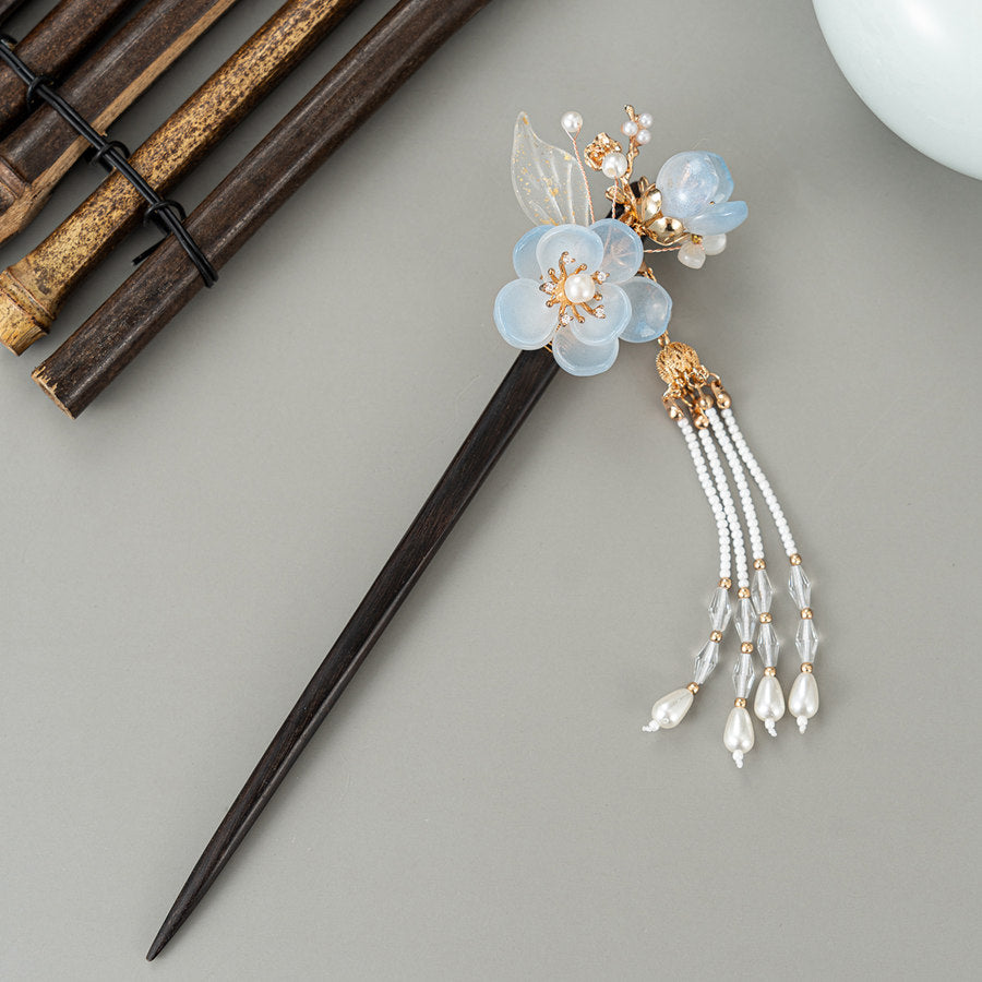 Front view of smooth stick with blue flower and tapered end