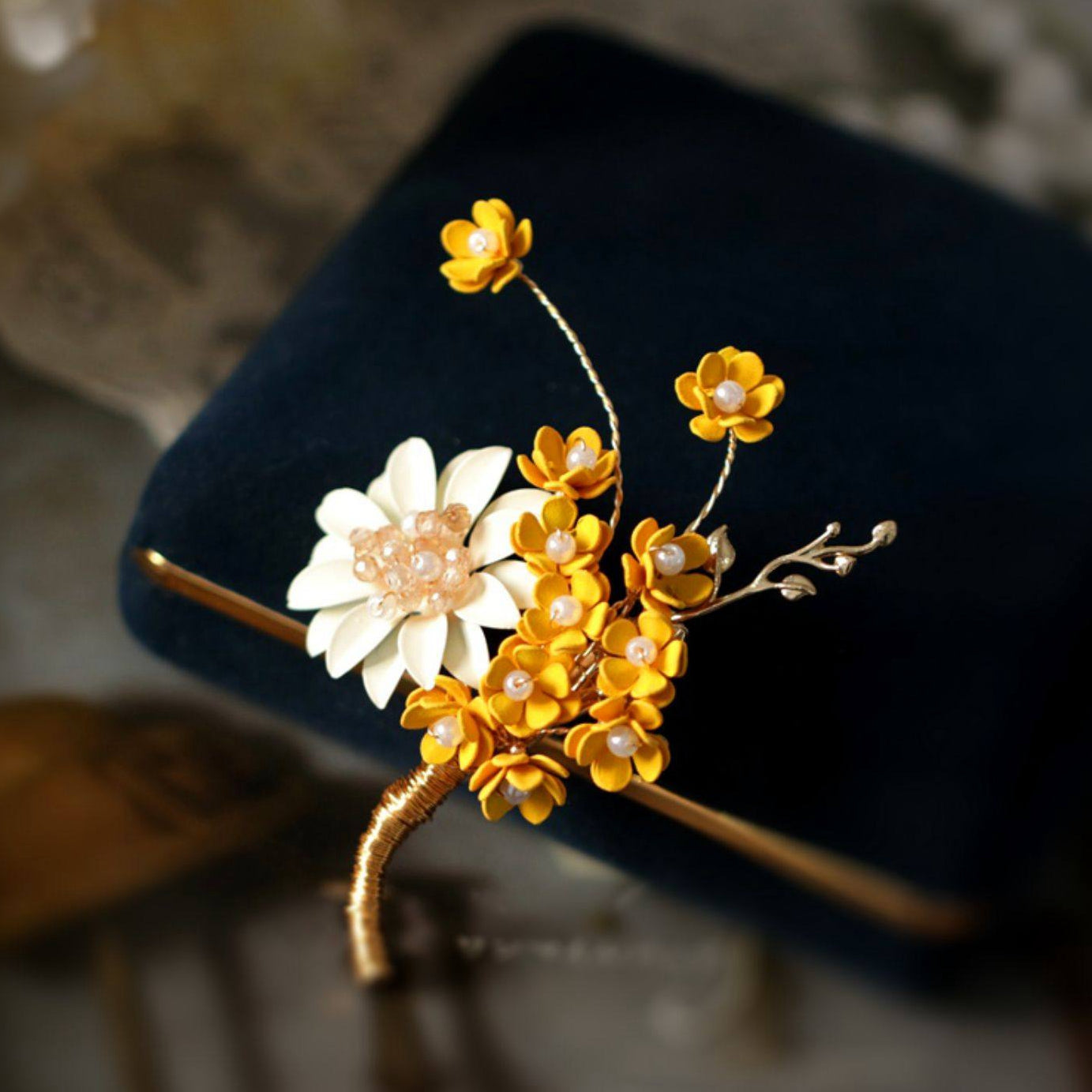Brooch pinned to coat lapel showing layered petals and warm metallic tone