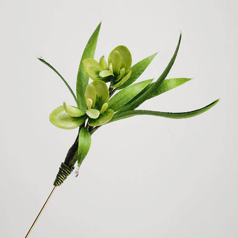 Angled shot of leaf design resting on fabric, ideal for styling
