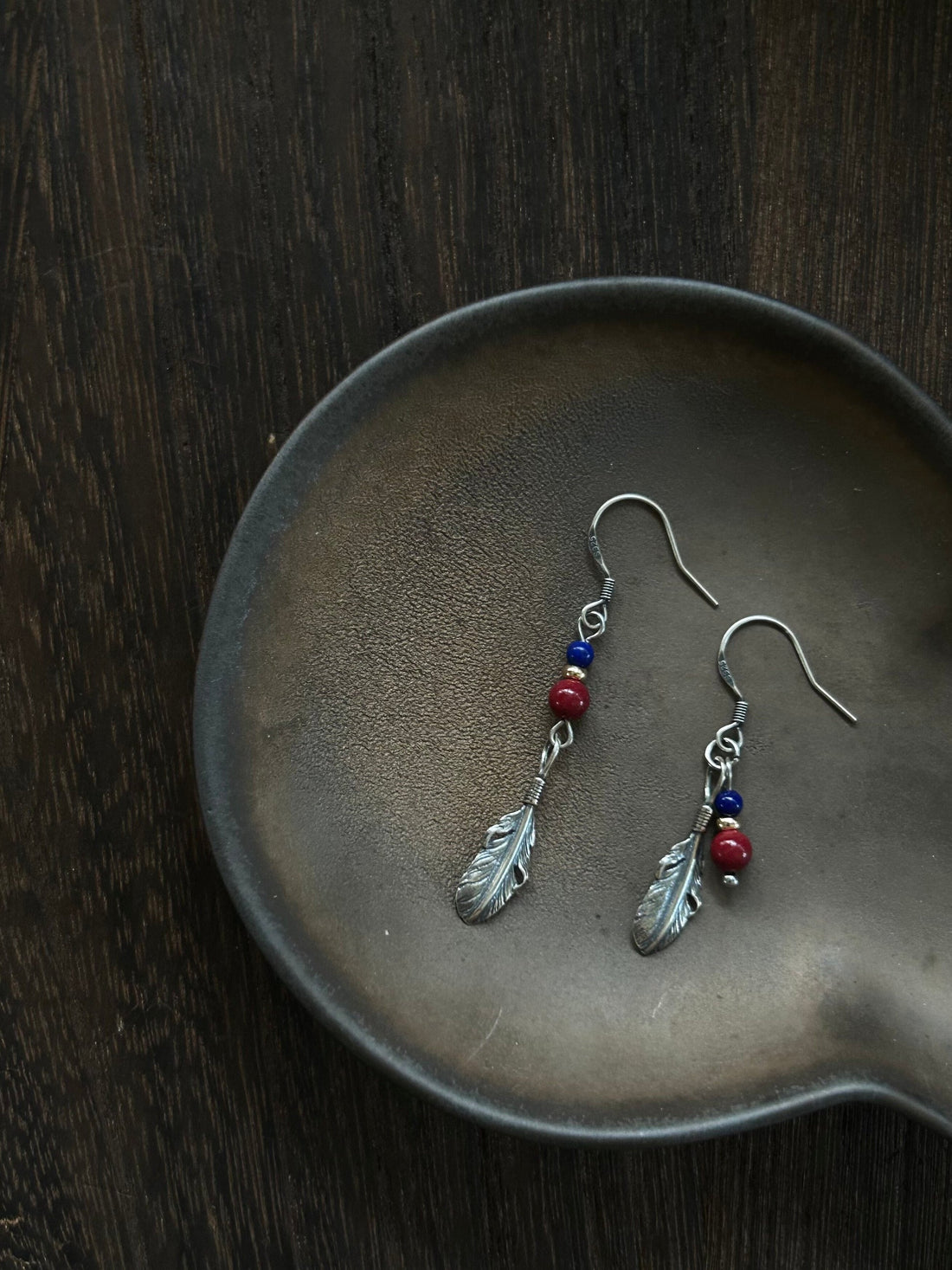 Asymmetrical S925 feather drop earrings with green stone beads and blue accents