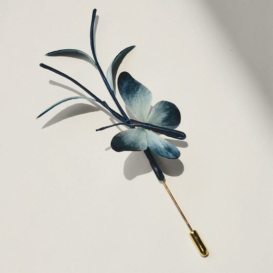 Full-length blue dragonfly brooch shown flat with long slender pin
