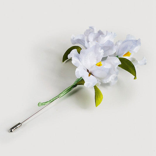 White lily brooch pin on a wedding guest dress