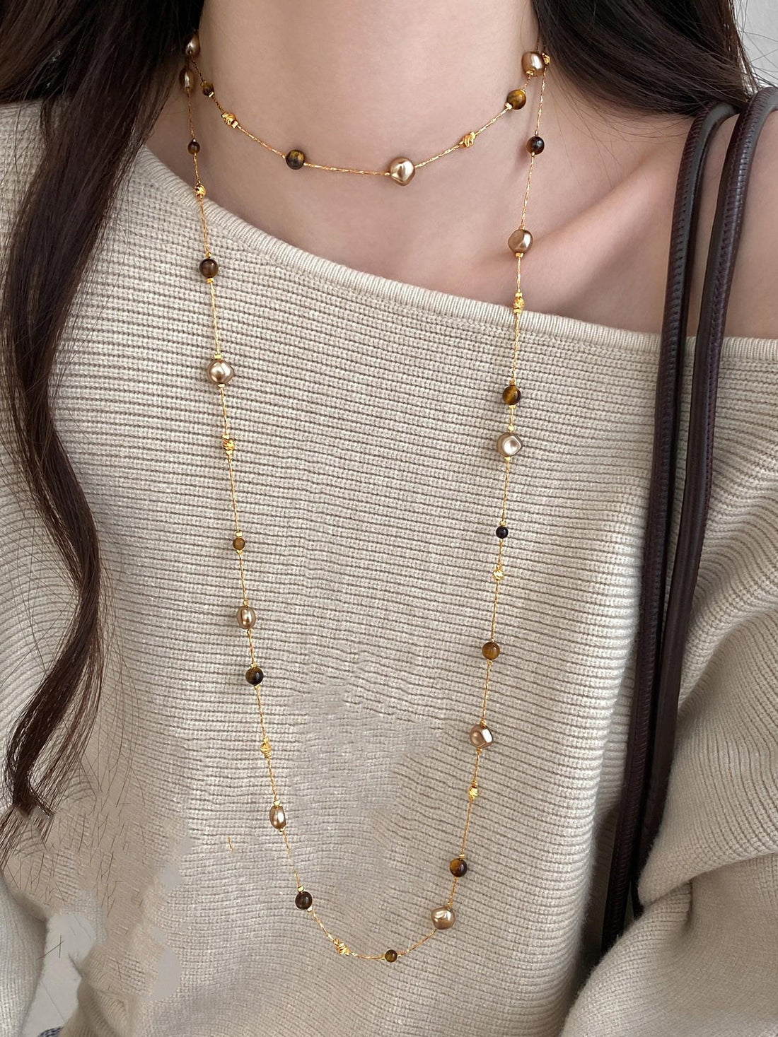 Long tiger-eye beaded sweater chain necklace styled as an earthy everyday layer