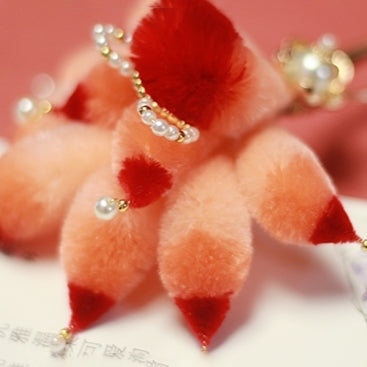 Hair stick pictured flat on fabric beside bridal ribbon and silk cloth