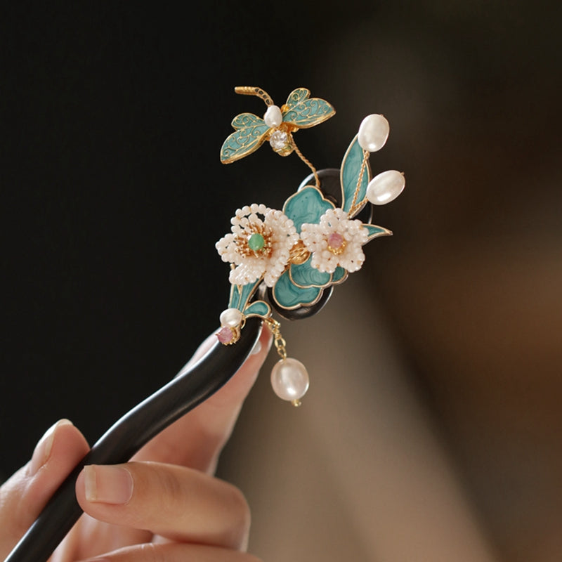 Side view showing curved floral engraving and tapered tip in bun