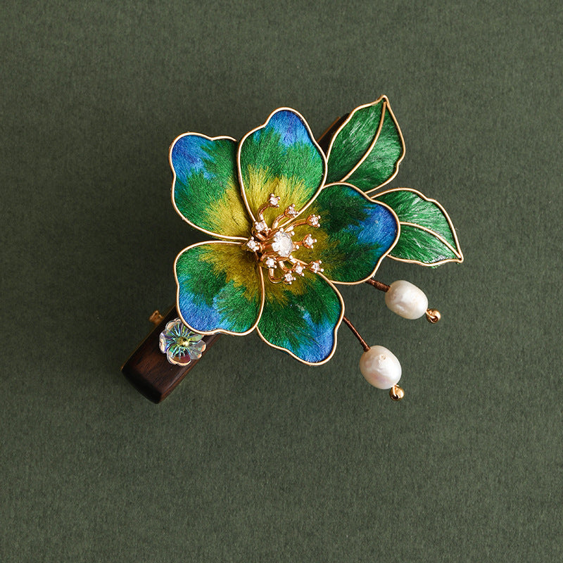 Model wearing the hair stick, floral end peeking above a sleek bun
