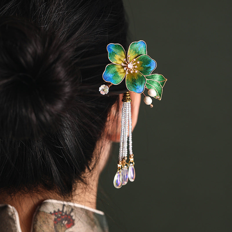 Side profile showing wood-look stick sliding through an elegant chignon