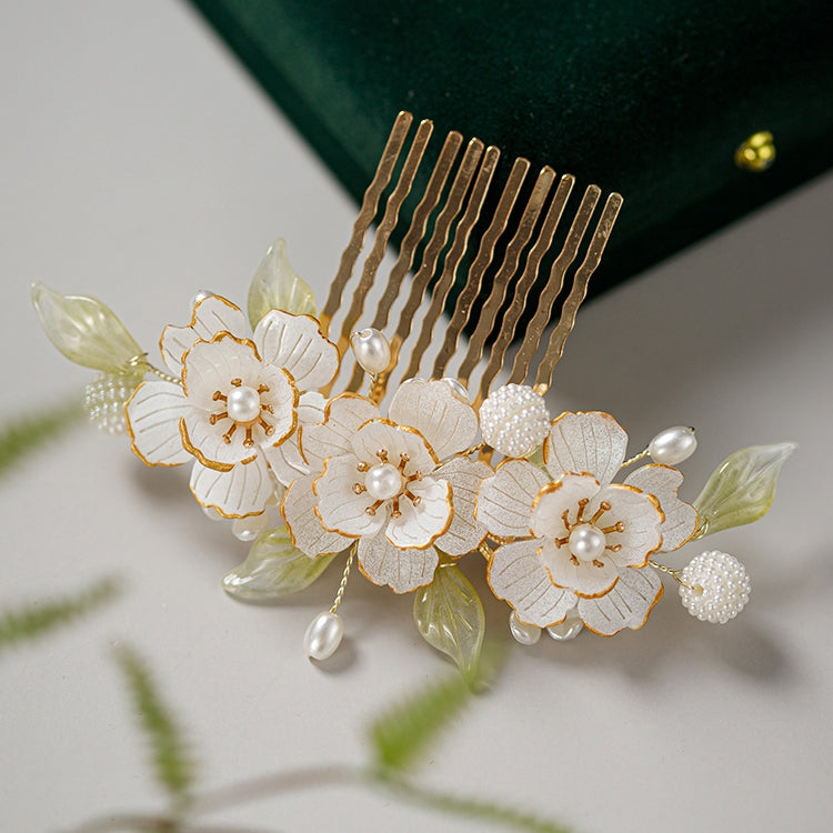 Close-up of warm gold rose accent on curved clip, worn in bun