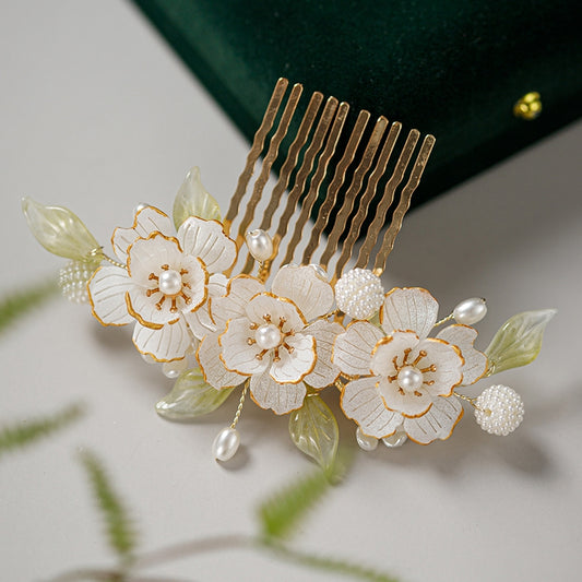 Close-up of warm gold rose accent on curved clip, worn in bun