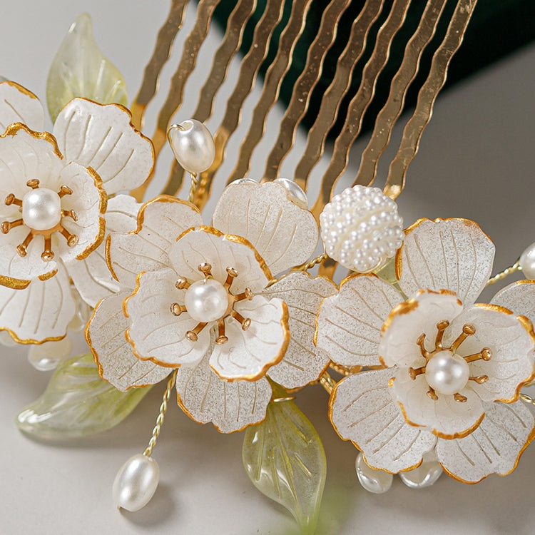 Styled in an elegant updo, warm gold rose clip catches light against dark hair