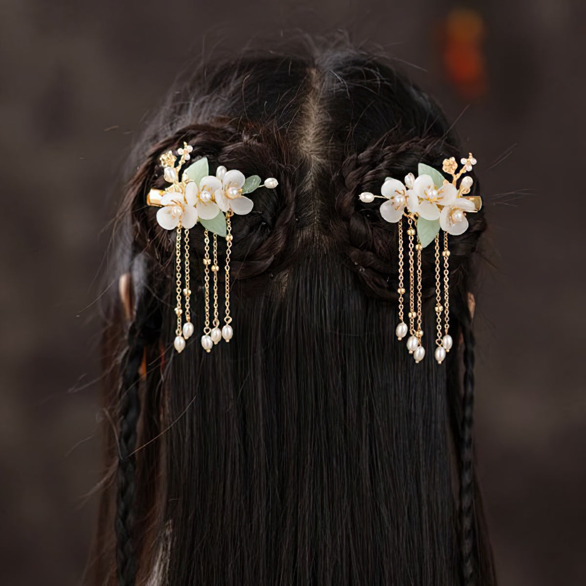 Hair stick securing an elegant side bun with soft silk ribbon detail