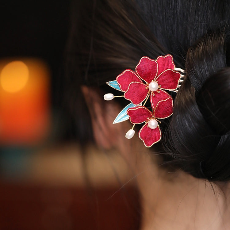 Close-up showing delicate carved petals and warm brown surface sheen on stick
