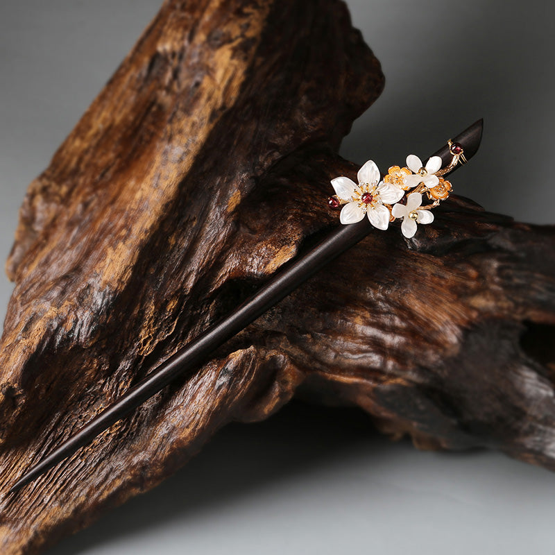 Laid across an open wooden box beside vintage ribbon for display