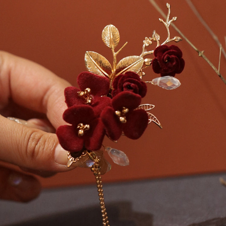 Detail of smooth stick and floral motif resting against dark hair