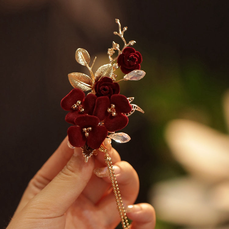 Overhead image of flower-topped stick placed across a low twisted bun