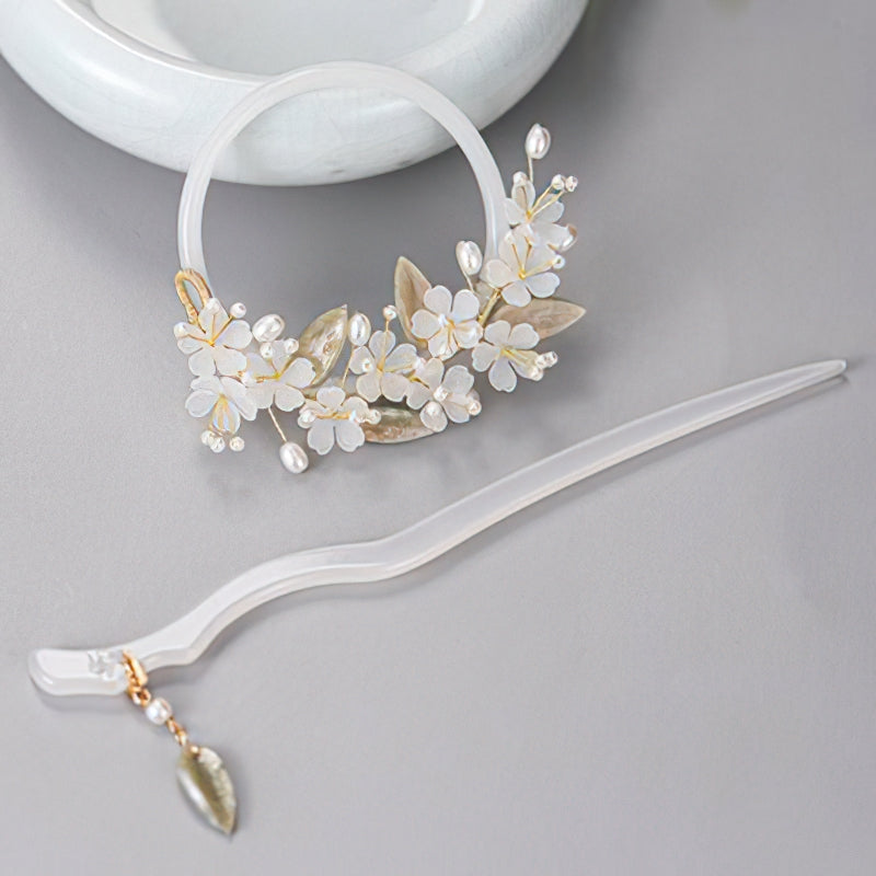 Side view of delicate jasmine motif hair stick holding a soft low bun