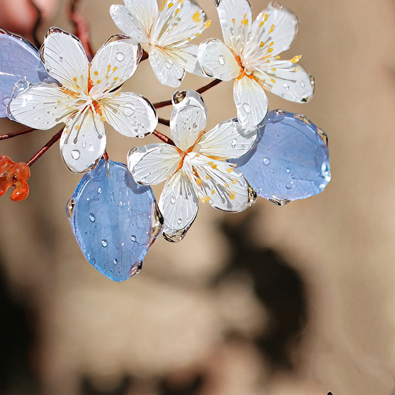 Delicate blossom cluster atop a U-shaped pin, shown securing a twisted updo