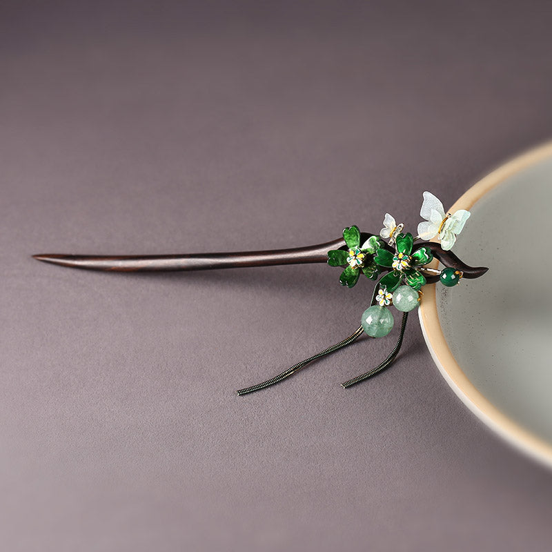 Hair stick placed horizontally with tassel visible beside styled bun