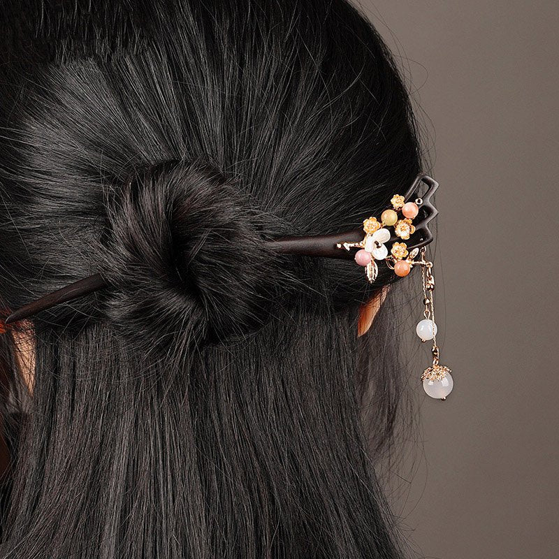 Styled with floral clip, the dark stick adds movement to an updo