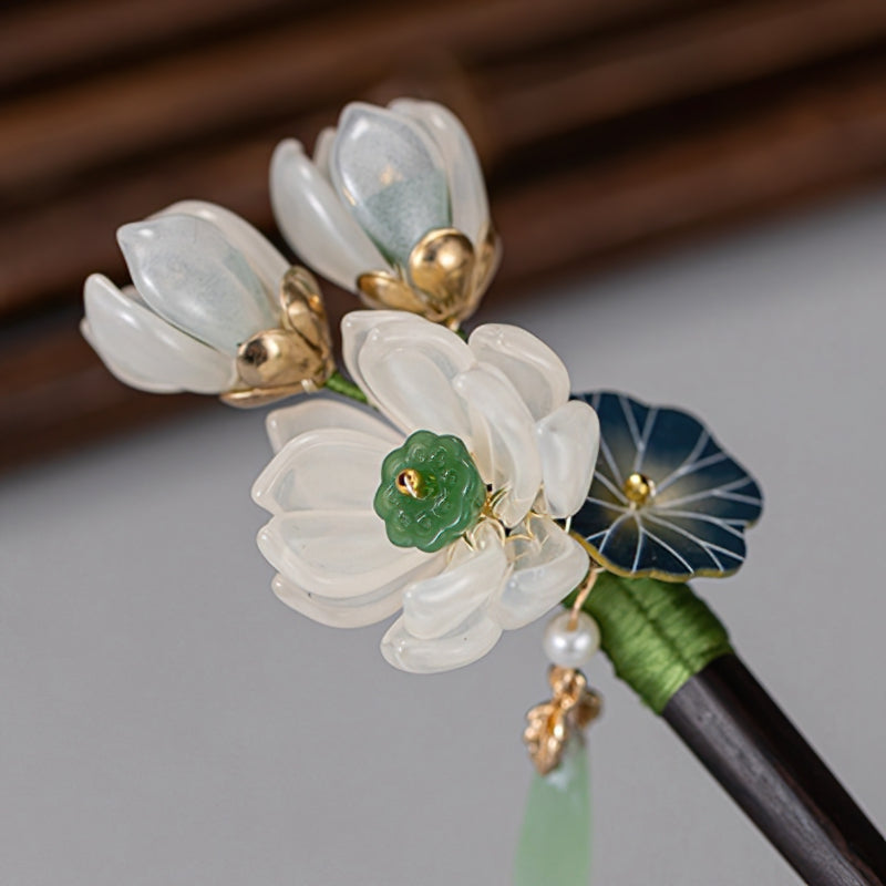 Pair of slender wooden sticks side by side on pale fabric
