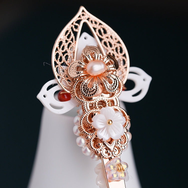 Close-up showing a floral motif and subtle metallic highlights on pin
