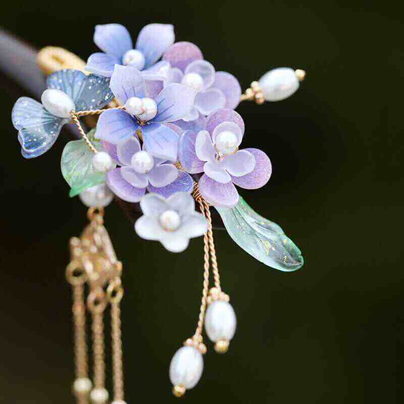 Styled with soft tendrils framing the face, the stick adds romantic detail