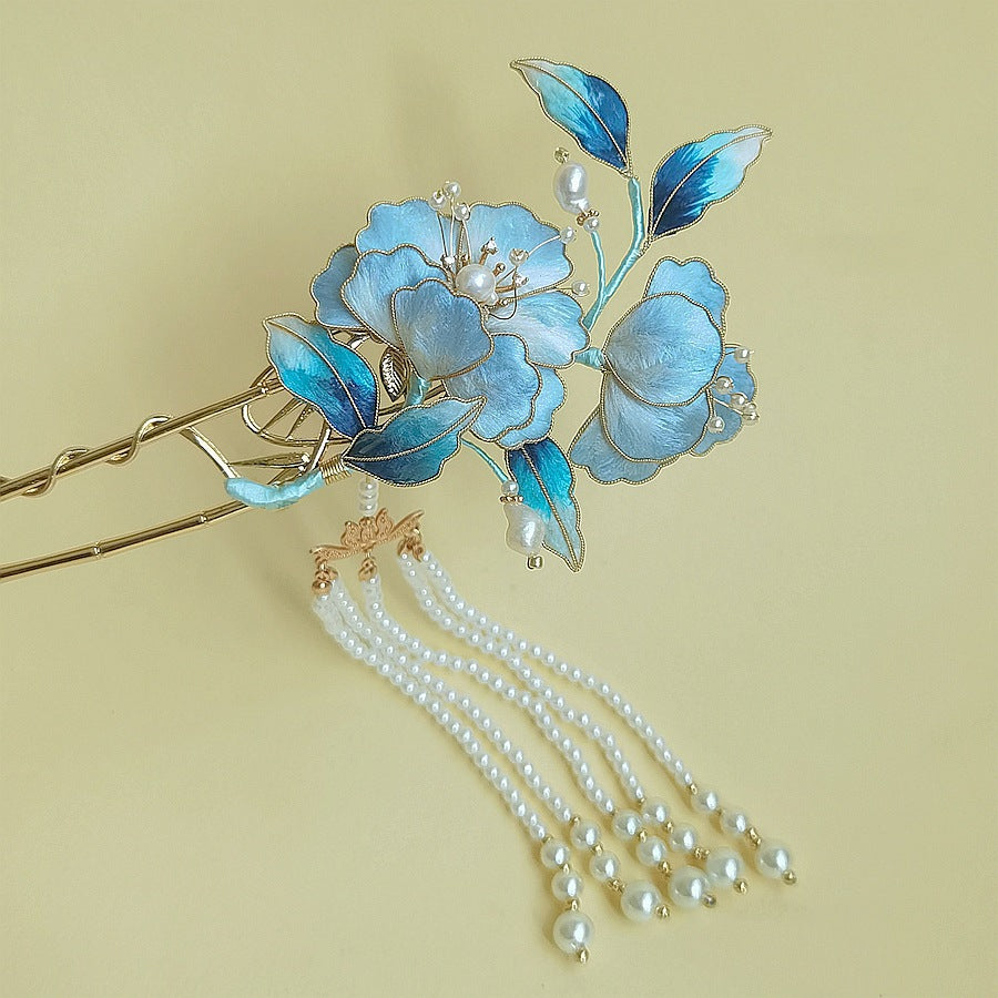 Close-up of golden petal detail beside slender wood-look hair stick