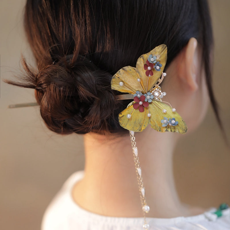 Side view showing sculpted butterfly wings catching light on hair