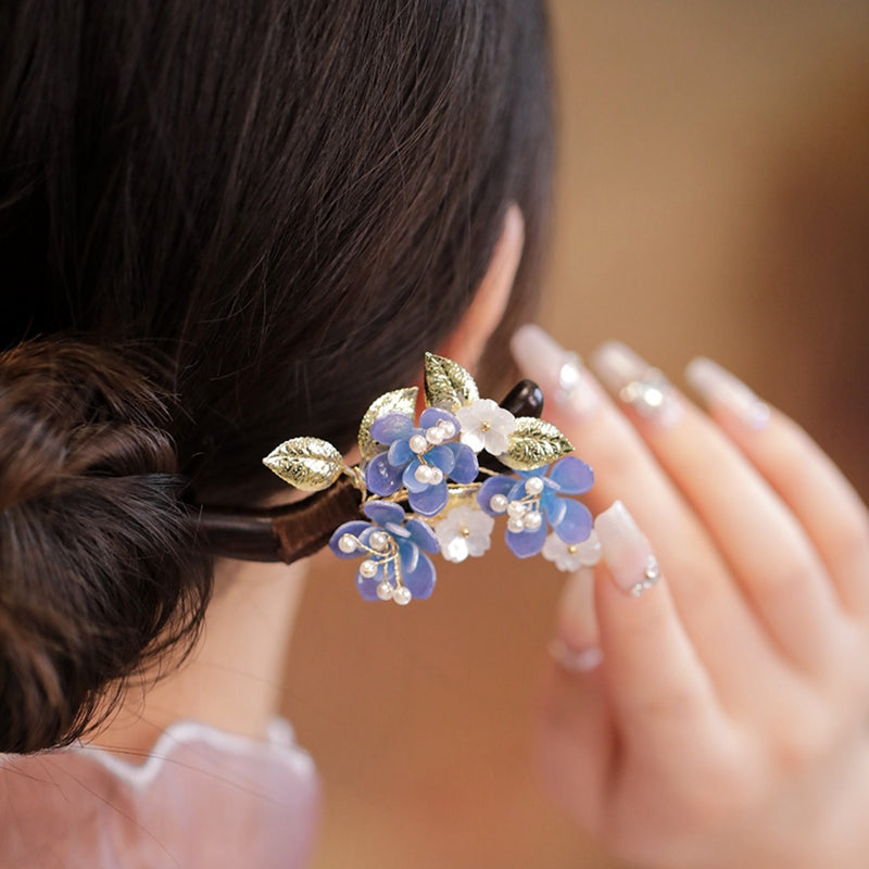Hair stick inserted into an elegant low bun on model profile