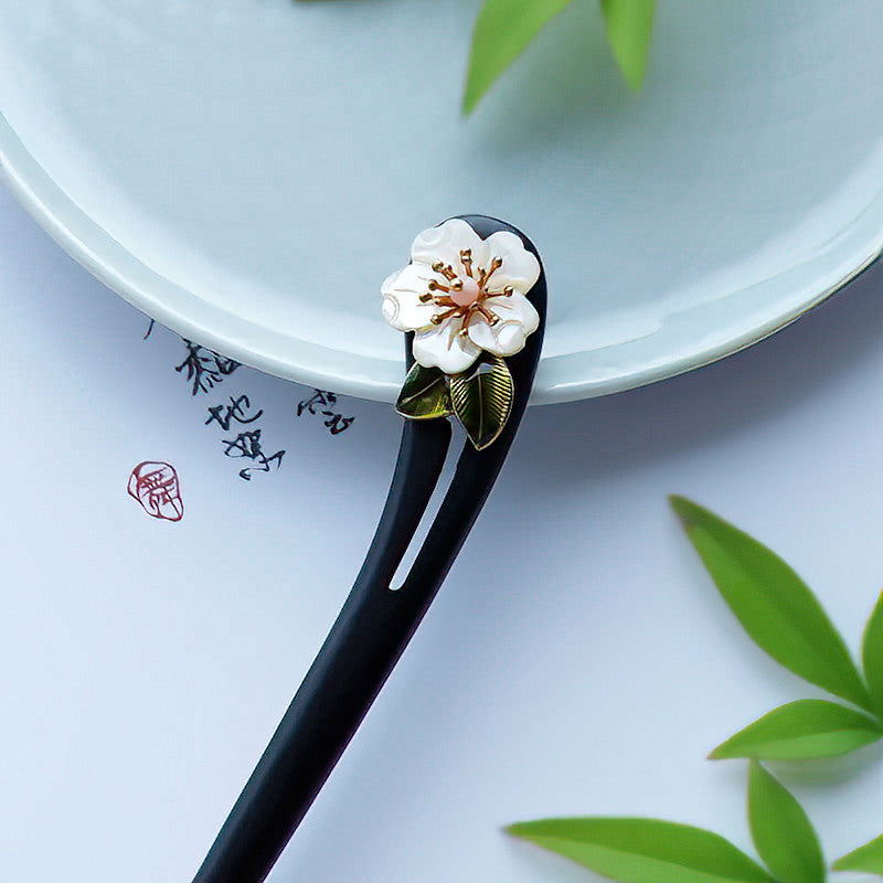 Hair stick styled in a low bun showing elegant silhouette
