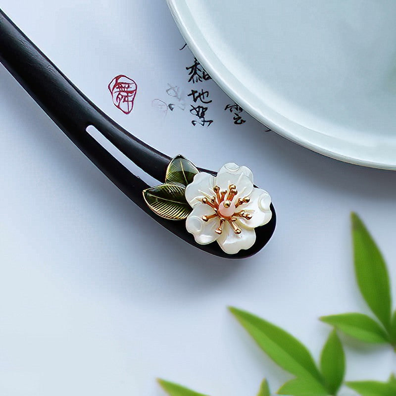 Close-up of floral inlay and smooth finish along stick shaft