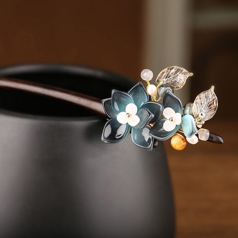 Laid on cream fabric, blue blossom contrasts with warm sandalwood-inspired tone