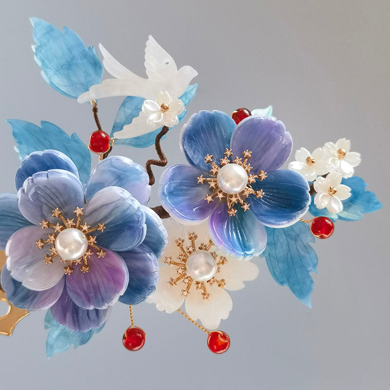 Slim stick threaded through hair with a blue bloom accent visible