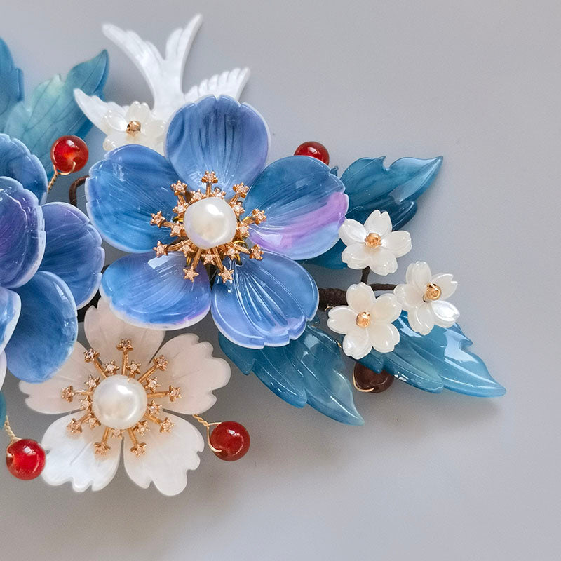 Styled with Hanfu-inspired updo; soft blue flower placed near crown