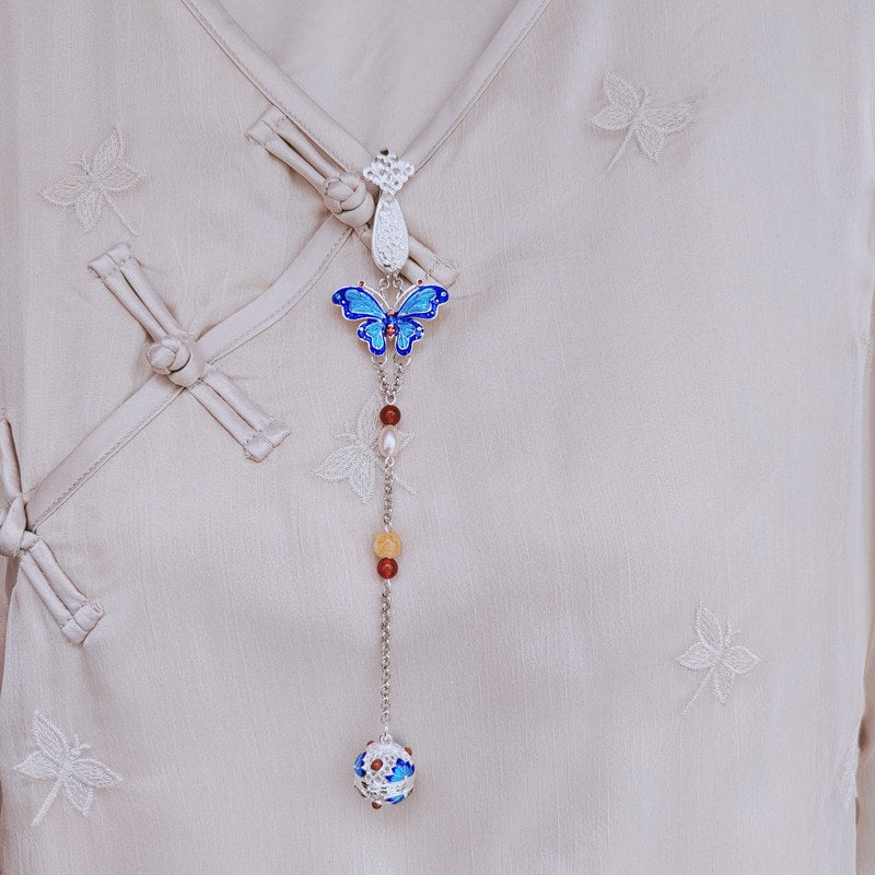 Side angle showing layered wings, tassel drape and pin fastening detail