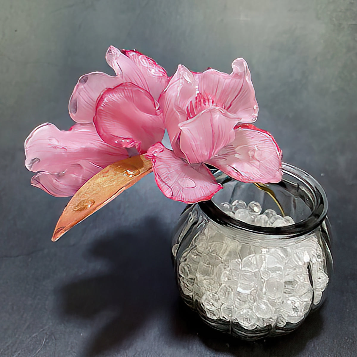 Styled in a low bun, iris-topped stick secures hair with subtle floral accent