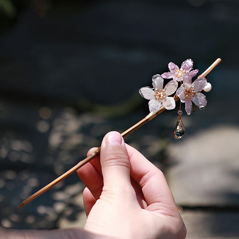 Side view showing delicate bamboo-inspired flower detail on hair stick