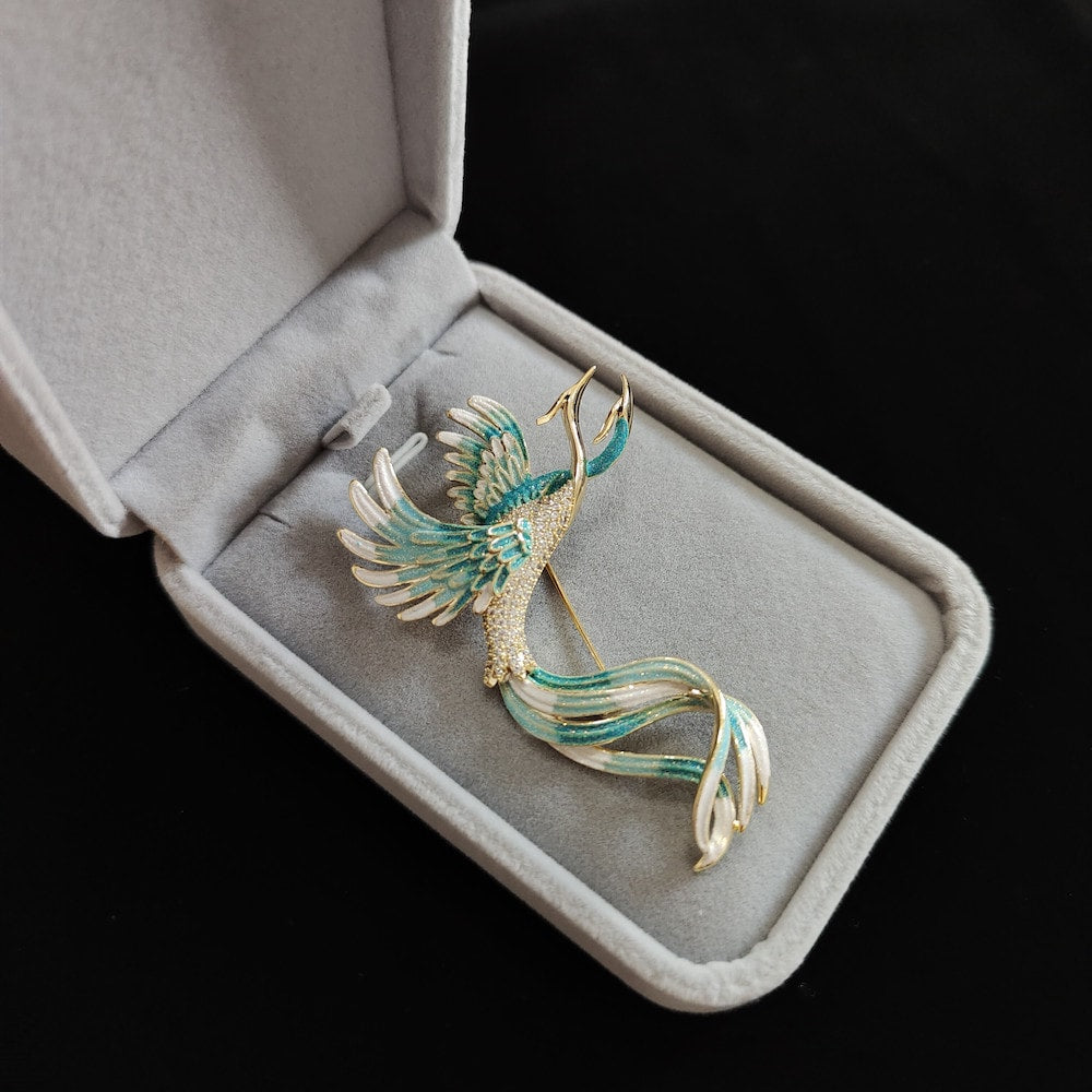 Gold-edged phoenix brooch with red and blue enamel, pinned on navy coat lapel