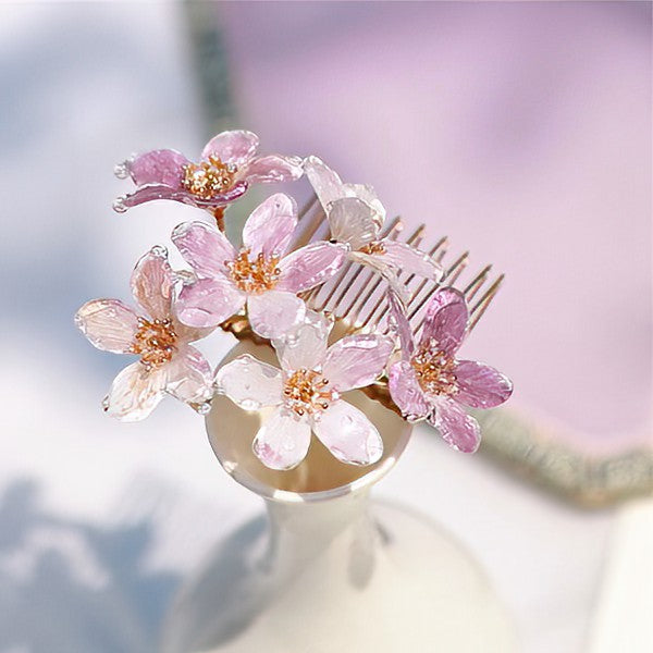 Three-quarter shot of cherry-blossom inspired comb placed at back of bun