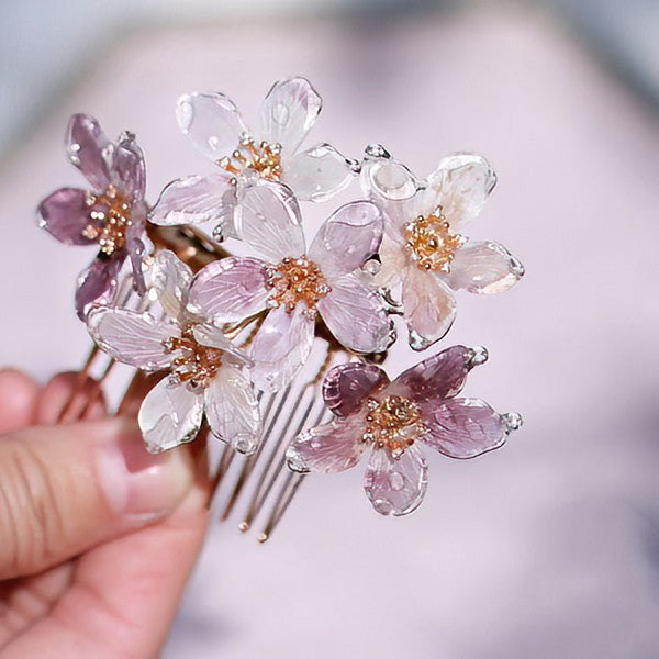 Side view of floral-tipped hair stick pinned into an elegant low bun
