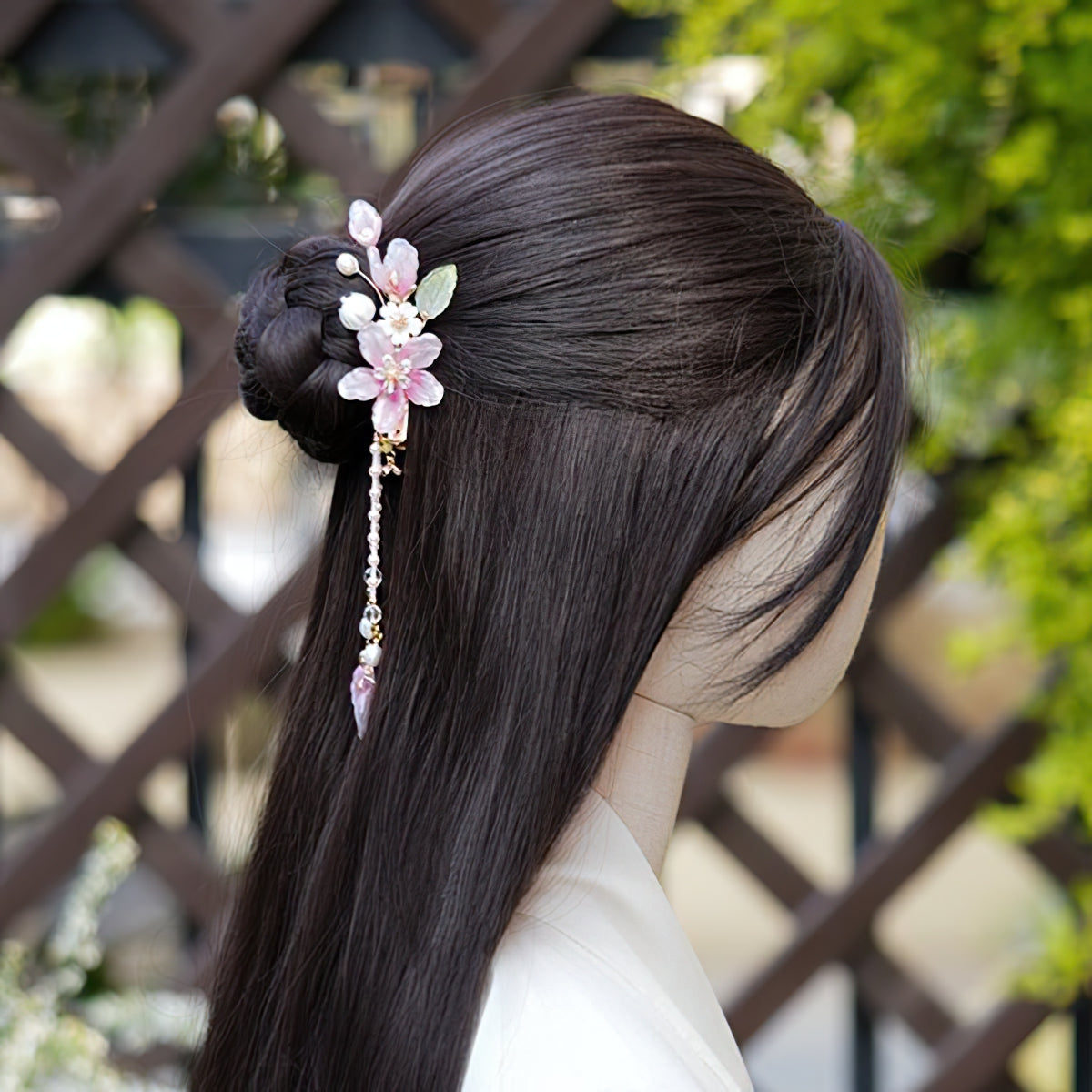 Ivory-toned floral barrette securing a half-up hairstyle at crown