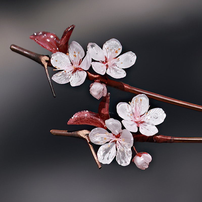 Side view of dark wooden-look stick with pale pink flower in low bun