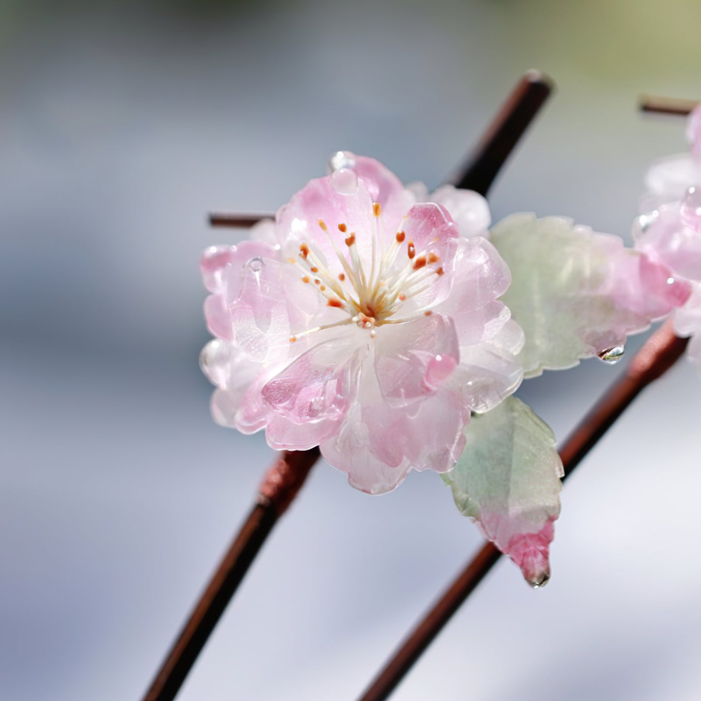 Two-piece assembly showing removable pin detail beside decorative blossom accent