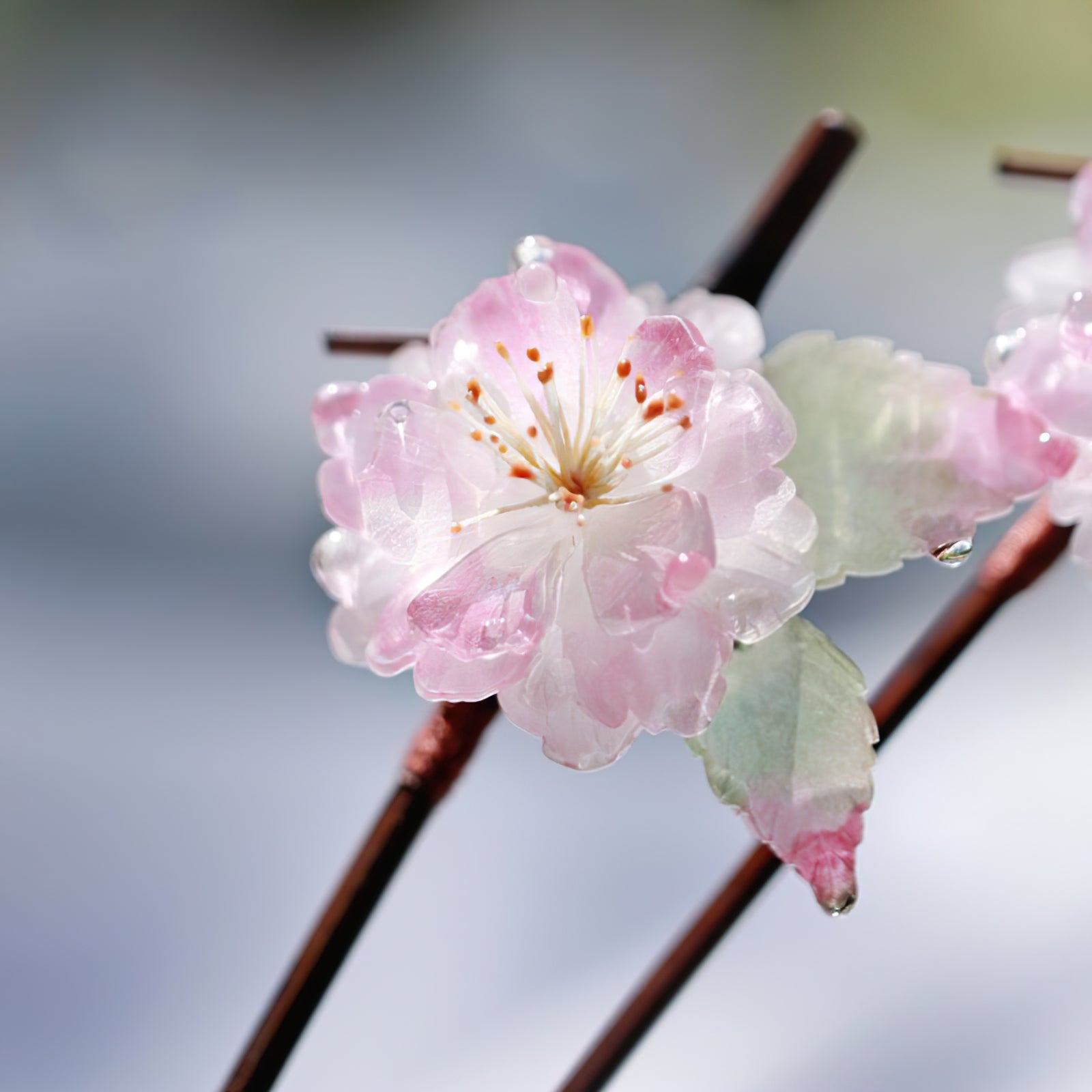 Two-piece assembly showing removable pin detail beside decorative blossom accent