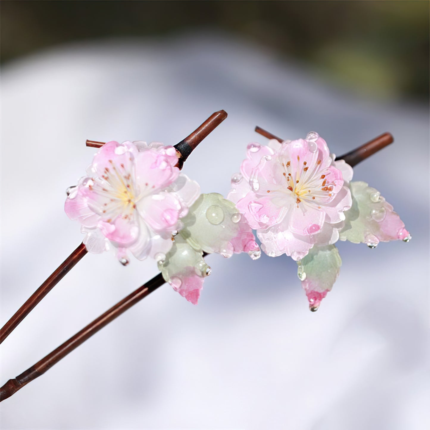 Close-up of engraved petals and warm wooden shaft held against a hand